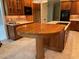 Kitchen with wood cabinetry, island with cooktop, and breakfast bar at 6553 Vintage Ridge Ln, Fuquay Varina, NC 27526