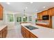 Spacious kitchen featuring wood cabinets, a center island, and plenty of natural light at 6553 Vintage Ridge Ln, Fuquay Varina, NC 27526