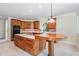 Gourmet kitchen features wood cabinets, modern appliances, and a large island with cooktop at 6553 Vintage Ridge Ln, Fuquay Varina, NC 27526