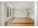 Spacious living room with hardwood floors, decorative trim, and abundant natural light at 6553 Vintage Ridge Ln, Fuquay Varina, NC 27526