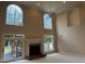 Spacious living room with high ceilings, fireplace, and access to the outdoor deck at 6553 Vintage Ridge Ln, Fuquay Varina, NC 27526