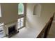 Open-concept living room with fireplace, large windows, and high ceilings, filled with natural light at 6553 Vintage Ridge Ln, Fuquay Varina, NC 27526