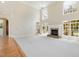 Large living room featuring lots of natural light, a fireplace, and access to an outdoor patio at 6553 Vintage Ridge Ln, Fuquay Varina, NC 27526
