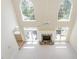 Bright living room with stone fireplace, ceiling fan, and multiple windows at 6553 Vintage Ridge Ln, Fuquay Varina, NC 27526