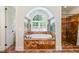 Luxurious main bathroom featuring an arched window, soaking tub and a tiled shower at 6553 Vintage Ridge Ln, Fuquay Varina, NC 27526