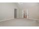 Spacious main bedroom with carpet floors and an opening to an en-suite bathroom at 6553 Vintage Ridge Ln, Fuquay Varina, NC 27526