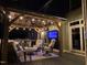 A well-appointed outdoor living space under a gazebo, featuring comfortable seating and a built-in grill at 6553 Vintage Ridge Ln, Fuquay Varina, NC 27526