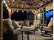 Cozy outdoor living space with ample seating and a grill, creating an inviting and functional area for relaxation at 6553 Vintage Ridge Ln, Fuquay Varina, NC 27526