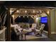 Relaxing outdoor lounge boasts comfortable seating, a built-in grill, and a TV, creating an ideal entertainment space at 6553 Vintage Ridge Ln, Fuquay Varina, NC 27526
