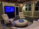 Comfortable covered patio with chairs and ottoman, creates an inviting outdoor living space for relaxation and enjoyment at 6553 Vintage Ridge Ln, Fuquay Varina, NC 27526