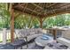 This outdoor living area has comfortable seating and a full outdoor kitchen and cooking area at 6553 Vintage Ridge Ln, Fuquay Varina, NC 27526