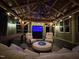 Outdoor living space featuring a covered patio, outdoor television, and comfortable seating, ideal for entertaining or relaxation at 6553 Vintage Ridge Ln, Fuquay Varina, NC 27526