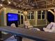 Inviting covered patio with comfortable seating, outdoor TV, and stylish decor, perfect for relaxation and entertainment at 6553 Vintage Ridge Ln, Fuquay Varina, NC 27526