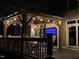 Stylish covered outdoor living space with TV, comfortable seating, and elegant lighting, ideal for entertaining or relaxation at 6553 Vintage Ridge Ln, Fuquay Varina, NC 27526