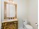 Elegant powder room with ornate vanity, decorative mirror, and classic fixtures at 6553 Vintage Ridge Ln, Fuquay Varina, NC 27526