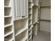 Walk-in closet with shelving, cabinets and rod racks at 6553 Vintage Ridge Ln, Fuquay Varina, NC 27526