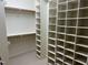 Spacious walk-in closet with shelving and hanging rods, perfect for organized storage at 6553 Vintage Ridge Ln, Fuquay Varina, NC 27526