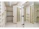 Spacious walk-in closet with custom shelving, mirror, and ample storage space at 6553 Vintage Ridge Ln, Fuquay Varina, NC 27526