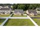 An aerial shot highlights a home with a fenced yard in a neighborhood surrounded by lush greenery at 6920 Moss Creek Way, Rocky Mount, NC 27804
