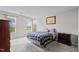 Bright bedroom with two windows providing natural light, carpet flooring, and neutral paint color at 6920 Moss Creek Way, Rocky Mount, NC 27804