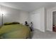Bedroom with a green bed cover, exercise equipment, soft carpet, and a standard closet with white door at 6920 Moss Creek Way, Rocky Mount, NC 27804
