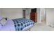 Bedroom with soft carpet, neutral paint and furniture; a dresser with a TV and a bathroom are visible at 6920 Moss Creek Way, Rocky Mount, NC 27804