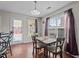 Cozy dining area with a table and chairs, featuring natural light from the adjacent door and window at 6920 Moss Creek Way, Rocky Mount, NC 27804
