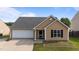 Charming single-Gathering home with attached garage, inviting curb appeal and a well maintained lawn at 6920 Moss Creek Way, Rocky Mount, NC 27804