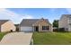 Charming single-Gathering home featuring a spacious two-car garage and a well-maintained front yard at 6920 Moss Creek Way, Rocky Mount, NC 27804