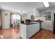 Bright kitchen features an island, appliances, dark countertop, and space for a table near the window at 6920 Moss Creek Way, Rocky Mount, NC 27804