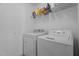Bright laundry room with white washer and dryer and shelf for supplies at 6920 Moss Creek Way, Rocky Mount, NC 27804