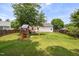 Spacious backyard with lush green grass and a wooden playset at 6924 Coventry Ridge Rd, Raleigh, NC 27616