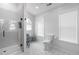 Stylish bathroom with tiled floors, a glass shower, and a large window offering plenty of natural light at 6924 Coventry Ridge Rd, Raleigh, NC 27616