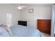 Bright bedroom featuring a ceiling fan, neutral walls, and an assortment of dressers for ample storage at 6924 Coventry Ridge Rd, Raleigh, NC 27616