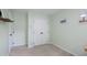 Minimalist bedroom with neutral walls, a closet with double doors, and natural light, creating a serene space at 6924 Coventry Ridge Rd, Raleigh, NC 27616