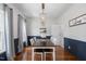 Elegant dining room with hardwood floors, wainscoting detail, pendant lighting, and neutral decor at 6924 Coventry Ridge Rd, Raleigh, NC 27616