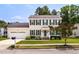 Traditional two-story home with attached garage, American flag, and well-maintained front lawn and garden at 6924 Coventry Ridge Rd, Raleigh, NC 27616