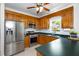 Kitchen with stainless steel appliances, wood cabinets, and dark countertops at 6924 Coventry Ridge Rd, Raleigh, NC 27616