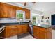Traditional kitchen boasts wood cabinets, stainless steel appliances, and a breakfast nook at 6924 Coventry Ridge Rd, Raleigh, NC 27616