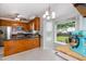 Bright kitchen with stainless appliances, wood cabinets, and breakfast nook at 6924 Coventry Ridge Rd, Raleigh, NC 27616