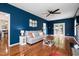 Open-concept living room with hardwood floors, fireplace, ceiling fan, and French doors to the backyard at 6924 Coventry Ridge Rd, Raleigh, NC 27616