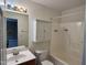 Well-lit bathroom features a vanity with sink, toilet, and tub/shower, providing all essential amenities in one convenient space at 7331 Bonnie Ridge Ct, Raleigh, NC 27615