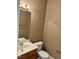 Cozy half bathroom features a sleek vanity and toilet, efficiently utilizing space with neutral color palette at 7331 Bonnie Ridge Ct, Raleigh, NC 27615
