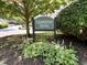 Celebration Square community entrance with beautiful landscaping and mature trees at 7331 Bonnie Ridge Ct, Raleigh, NC 27615