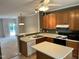 Kitchen featuring wood cabinets, island and open floorplan at 7331 Bonnie Ridge Ct, Raleigh, NC 27615