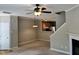 Living room with ceiling fan, fireplace, open to kitchen and staircase at 7331 Bonnie Ridge Ct, Raleigh, NC 27615
