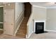 Inviting living room with fireplace and staircase, offering a warm, welcoming atmosphere for relaxation and entertainment at 7331 Bonnie Ridge Ct, Raleigh, NC 27615