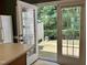 The backyard patio is viewed through the kitchen's french doors, offering easy outdoor access for dining or relaxation at 7331 Bonnie Ridge Ct, Raleigh, NC 27615
