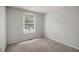 Cozy bedroom features a large window for natural lighting and neutral walls at 7731 Kingsberry Ct, Raleigh, NC 27615