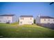 Wide shot of a backyard with a wooden fence and green grass at 8021 Wesley Farm Dr, Raleigh, NC 27616